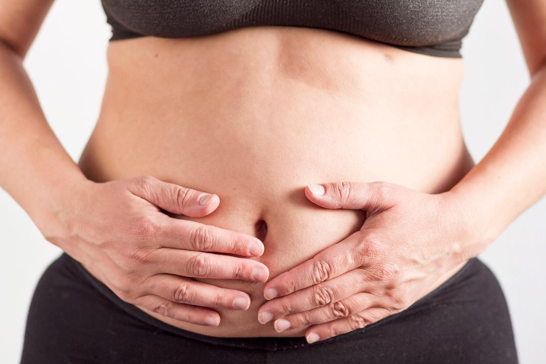 Picture of a lady having a bloated tummy