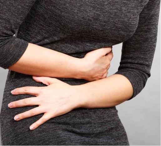 Picture of a lady experiencing stomach discomfort